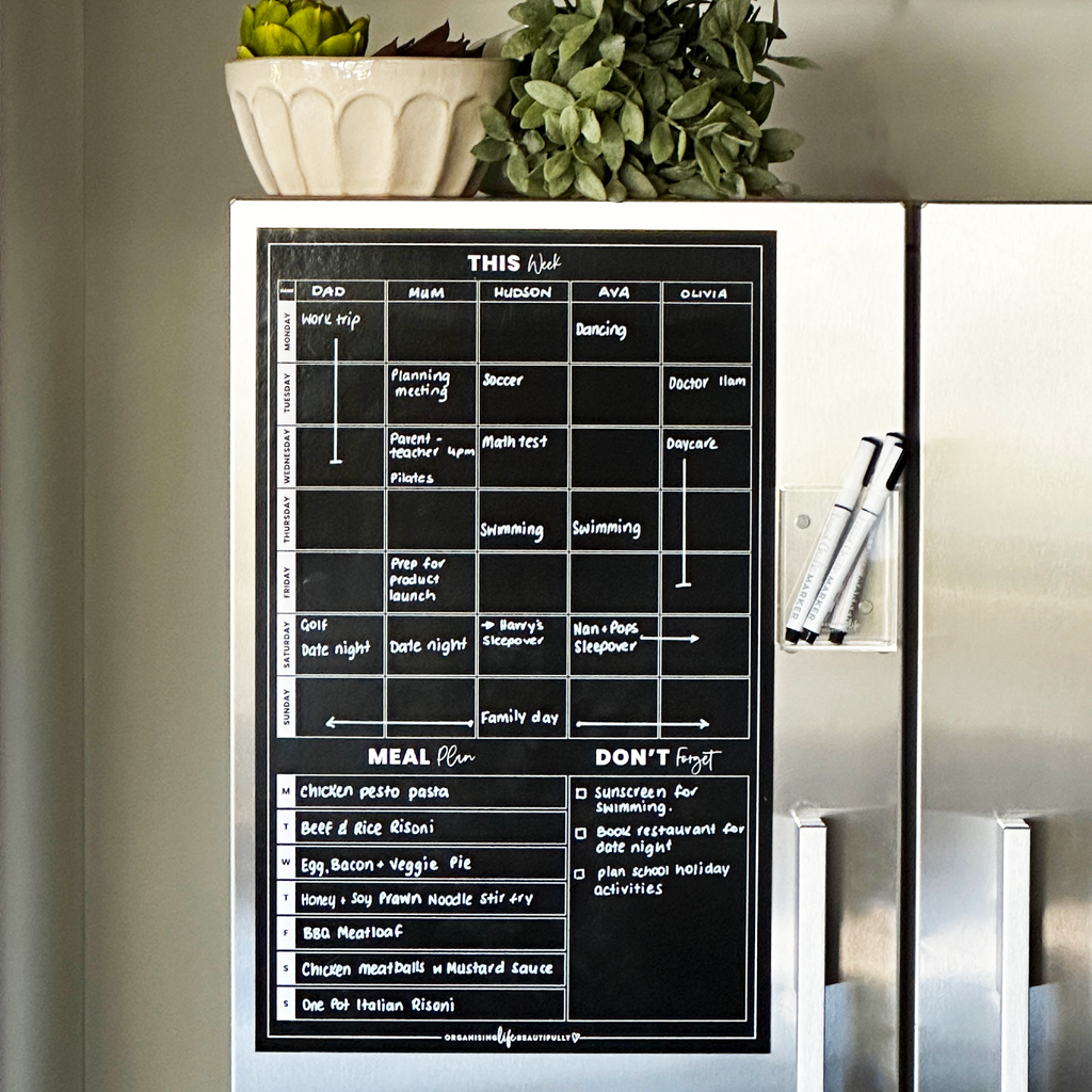 Black fridge planner with writing shown on a fridge with liquid chalk markers - Organising Life Beautifully 