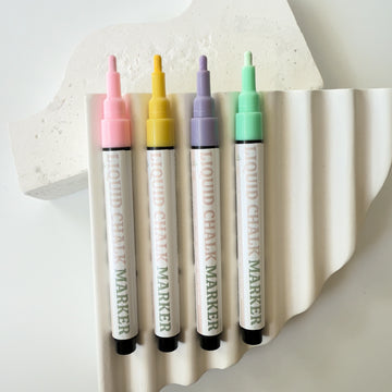 Coloured liquid chalk markers in pastel pink yellow purple and green