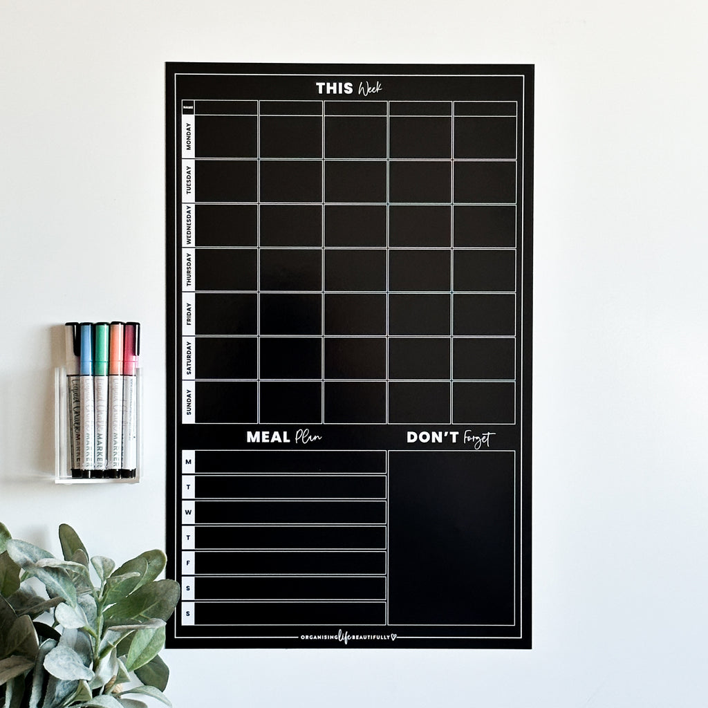 Black planner shown on a magnet board with liquid chalk markers - Organising Life Beautifully 
