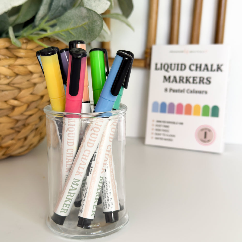 Bright colourful liquid chalk markers in an acrylic marker holder